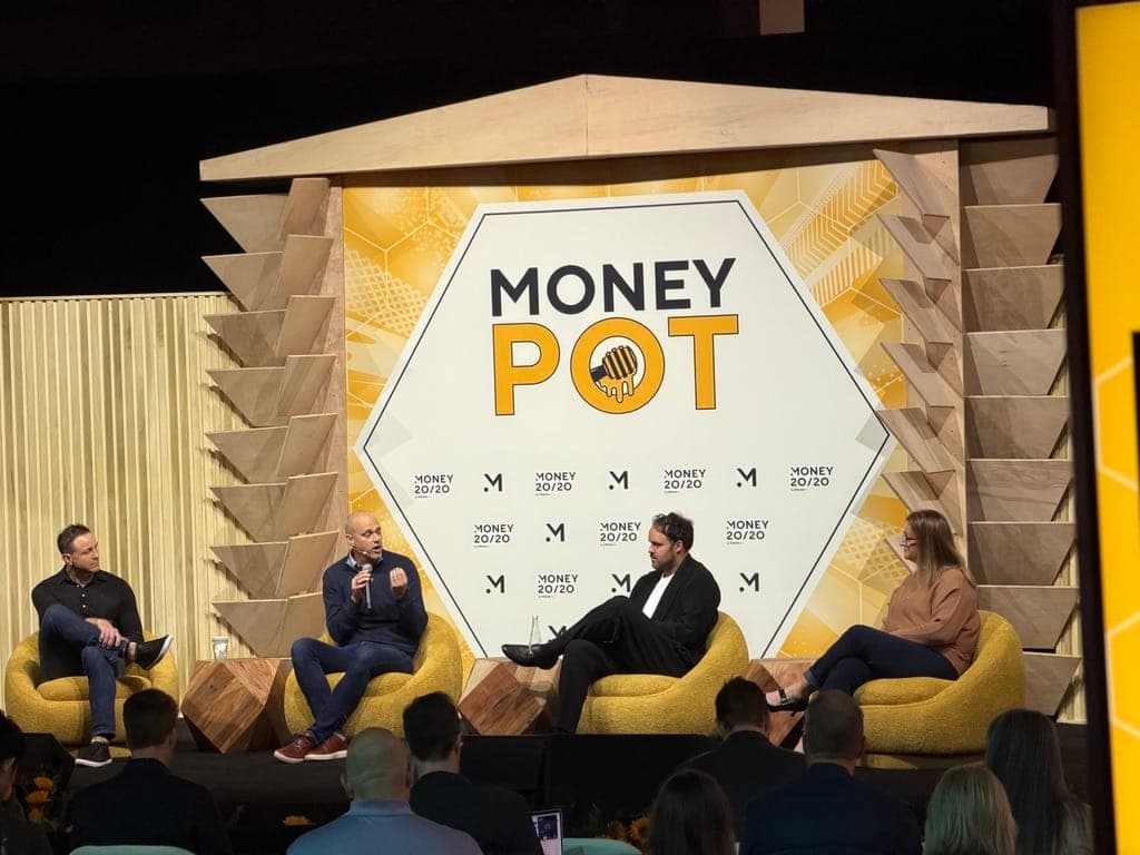 Four panelists seated on the MoneyPot stage at Money20/20, one speaking into a microphone, with the audience in the foreground.